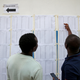 Voters search for their names on an electorate list near a polling station ahead of the presidential election, in Nairobi, Kenya August 7, 2017.